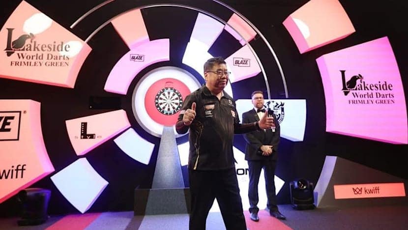 Singapore’s Paul Lim, 71, becomes oldest winner of match at World Darts Championship